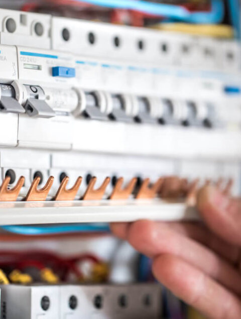 man-electrical-technician-working-switchboard-with-fuses-installation-connection-electrical-equipment-close-up (2) (1)